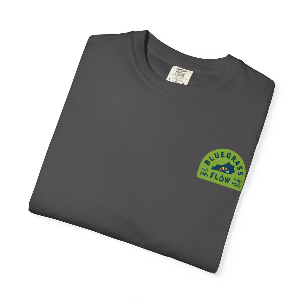 Folded charcoal t-shirt with a bluegrass flow logo on a white background