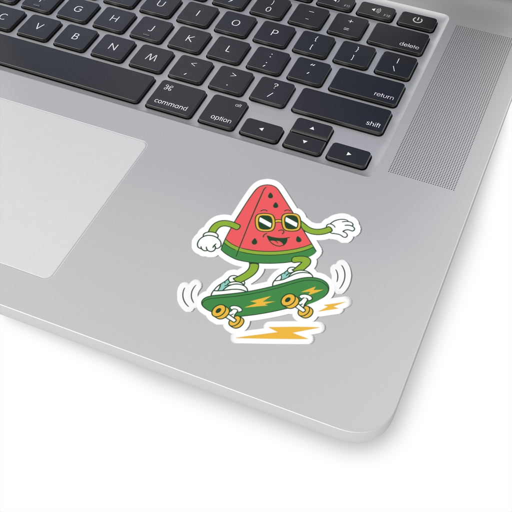 Laptop with a sticker of a watermelon character riding a skateboard on the palm rest area.
