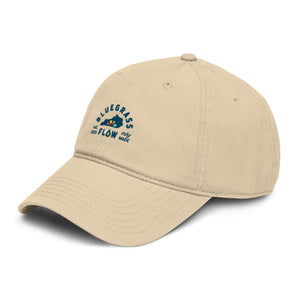Beige cap with blue and green bluegrass flow logo on a white background